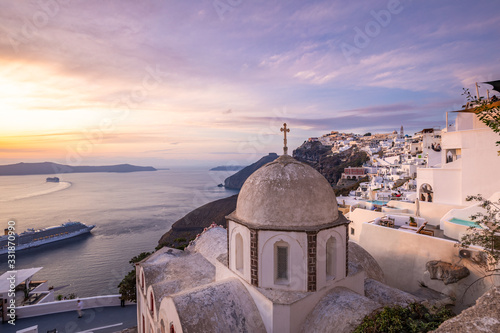 Evening view of Thira town and Aegean sea at sundown, Santorini Island, Greece. Beautiful summer landscape, sunset view. Tranquil travel background