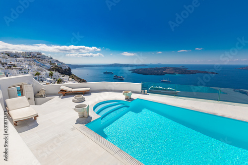 Swimming pool with sea view. White architecture on Santorini island, Greece. Beautiful landscape with blue sea view, luxury travel and vacation background © icemanphotos