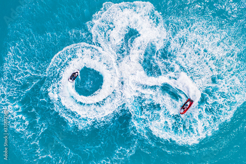 People are playing a jet ski in the sea. Aerial top view amazing nature background. The color of the water and beautifully bright. Fresh freedom, recreational adventure water sport © icemanphotos