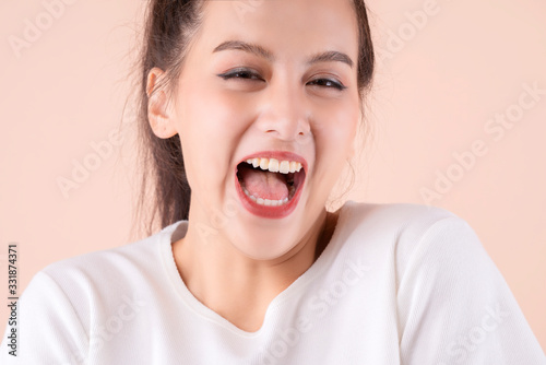 beautiful asian attractive female face close up casual dress laugh and big smile happiness surprise expression,pretty asian woman toothy smile wide mouth color background