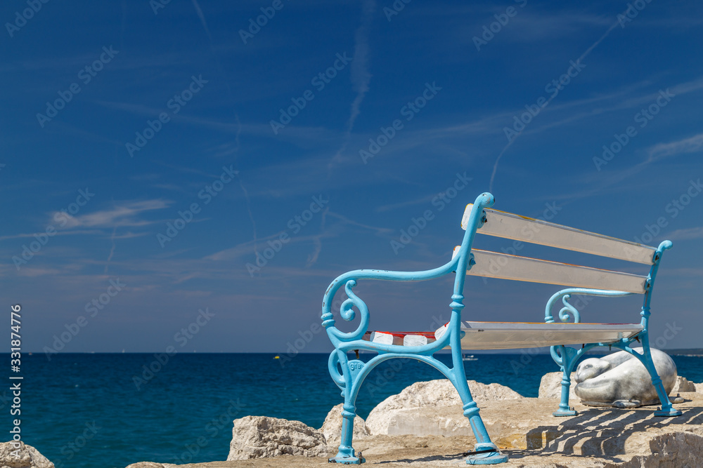 FAZANA / CROATIA - AUGUST 2015: Bench on the pier in Fazana town in Istria, Croatia