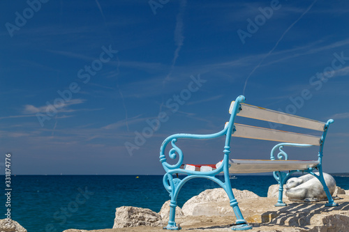 FAZANA / CROATIA - AUGUST 2015: Bench on the pier in Fazana town in Istria, Croatia