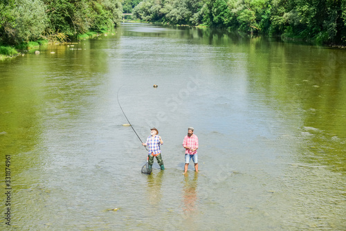one heartbeat. hobby and sport activity. Trout bait. recreation and leisure outdoor. father and son fishing. adventures. happy fisherman with fishing rod and net. Big game fishing. male friendship