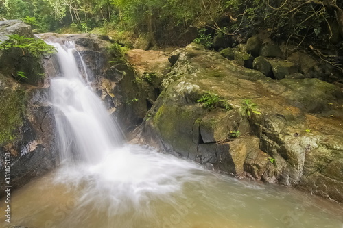 view nature of silky stream water flowing around with many arch rocks and green forest background  Phong Phra Bat Waterfall  Chiang Rai  northern of Thailand.