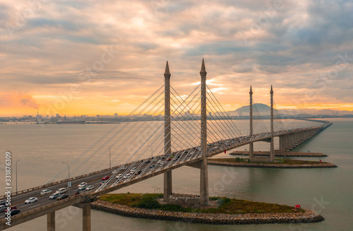 Aerial dramatic sunrise view with traffic at first Penang Bridge, Malaysia. 