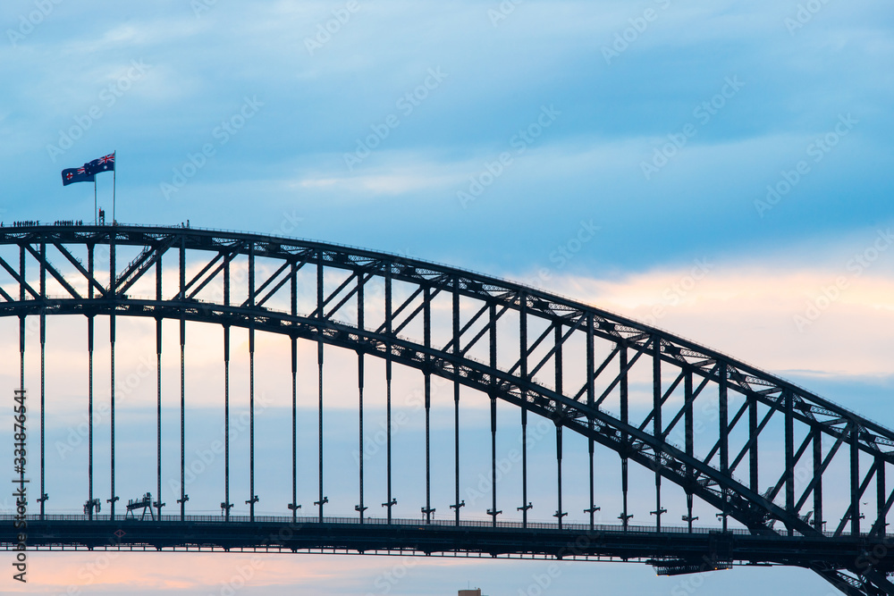 Sydney Harbour Bridge with cloudy blue sky.