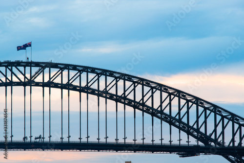 Sydney Harbour Bridge with cloudy blue sky.