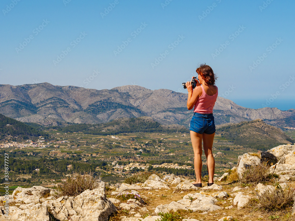 Woman take photo in mountains