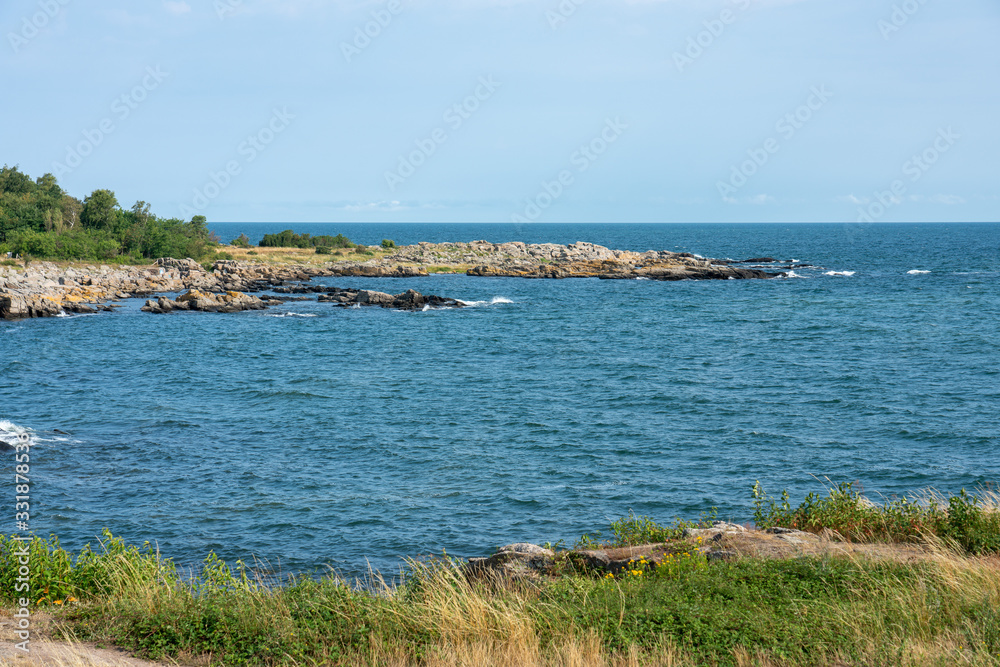 Svaneke, Bornholm / Denmark - July 29 2019: View of the rocky sea shore in Svaneke, Bornholm
