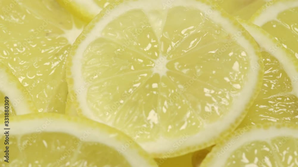 motion around delicious yellow juicy ripe lemon slices with thin zest at bright light extreme closeup motion around delicious yellow juicy ripe lemon slices with thin zest at bright light extreme closeup