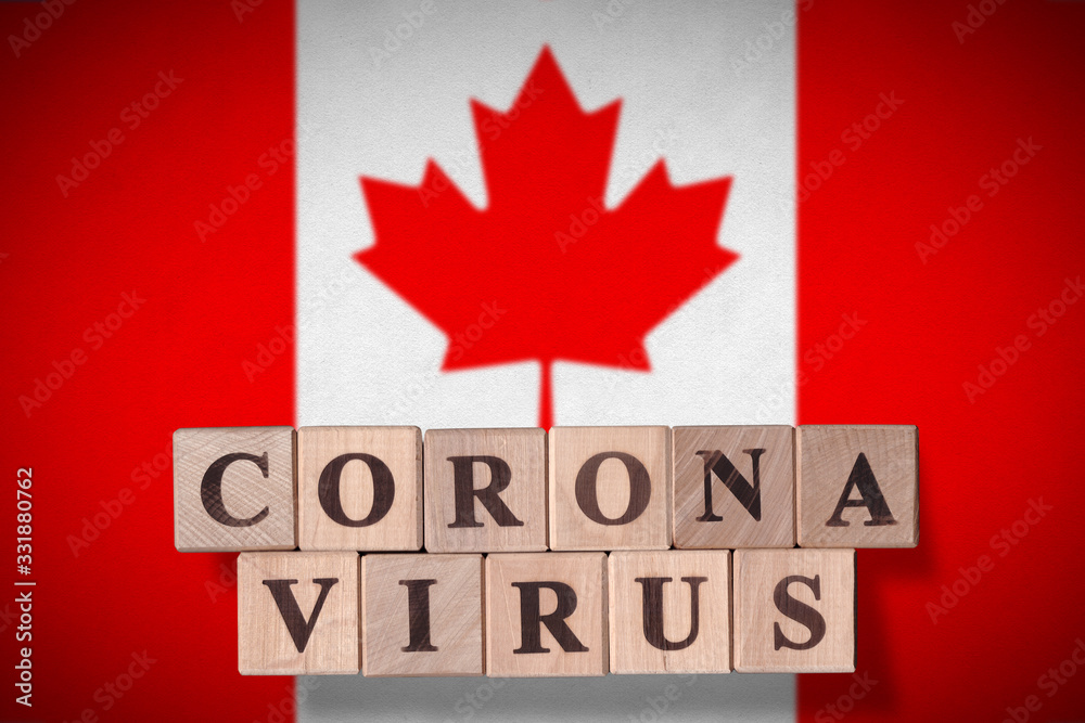 Flag of Canada with wooden cubes spelling Coronavirus on it. 2019 - 2020 Novel Coronavirus (2019-nCoV) concept, for an outbreak occurs in Canada. Flag of Canada with wooden cubes spelling Coronavirus on it. 2019 - 2020 Novel Coronavirus (2019-nCoV) concept, for an outbreak occurs in Canada.
