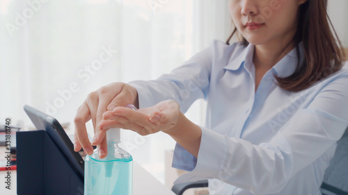Hand of woman pressing alcohol gel from bottle and applying sanitizer gel for hand wash to make cleaning and clear germ, bacteria, and virus. Pandemic protection, Hygienic and Health care concept.