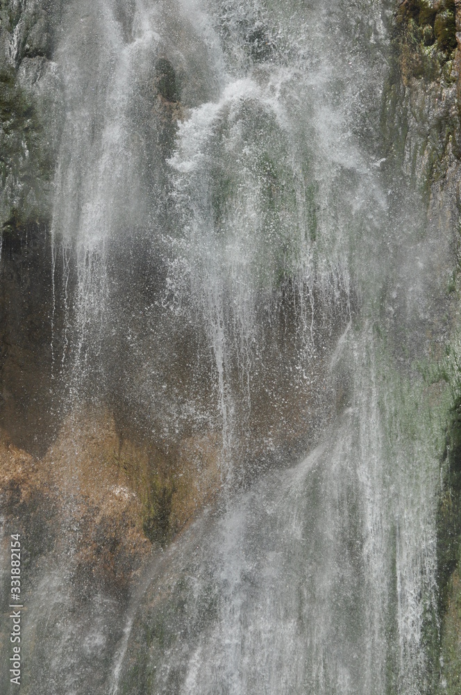 High waterfall, the water flowing from the rocks into the lake. National Park Plitvice Lakes. Tourism in Croatia. High waterfall, the water flowing from the rocks into the lake. National Park Plitvice Lakes. Tourism in Croatia.
