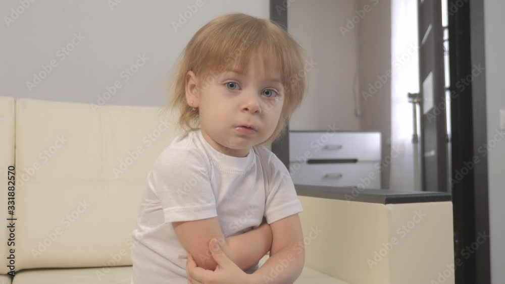 little a girl offended hugs herself with her hands. angry blonde girl lifestyle indoors little a girl offended hugs herself with her hands. angry blonde girl lifestyle indoors