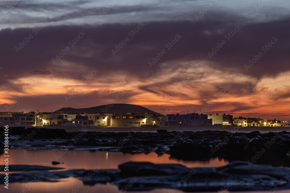 Caleta de Famara surfing village in Lanzarote at sunset