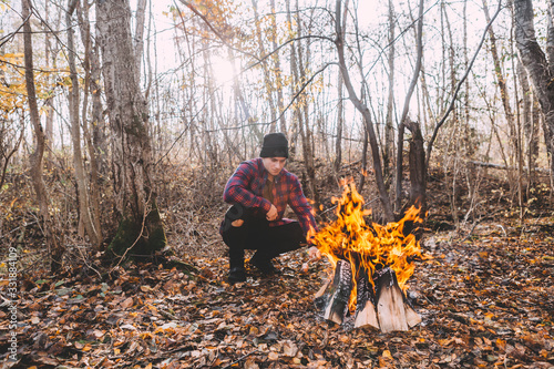 A man sitting near the campfire and enjoy the atmosphere. © Georgi