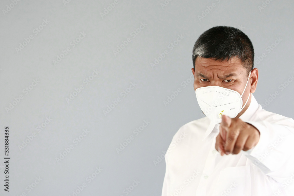 A asian man age 43 years with white shirt , wearing a mask Prevent germs Covid-19 , on gray background A asian man age 43 years with white shirt , wearing a mask Prevent germs Covid-19 , on gray background