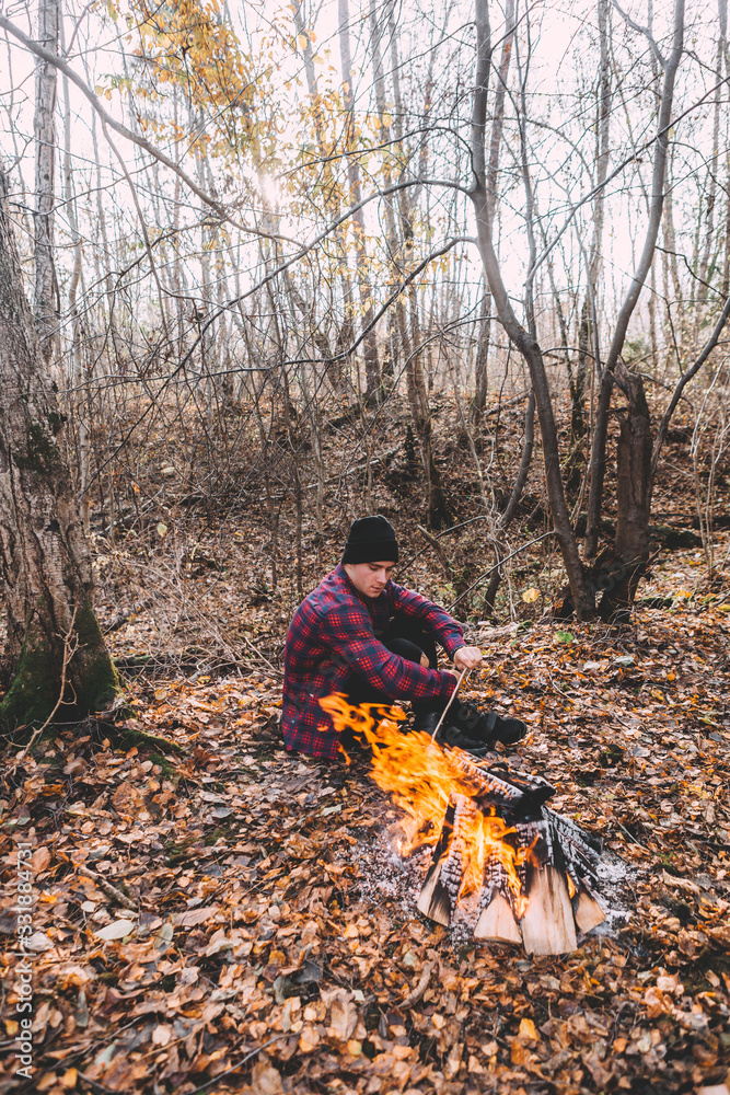 A man sitting near the campfire and enjoy the atmosphere. A man sitting near the campfire and enjoy the atmosphere.
