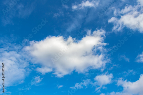 Blue sky with white curly cloud in sunny weather_