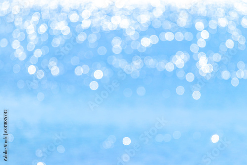 Abstract light blue background with white bokeh above_
