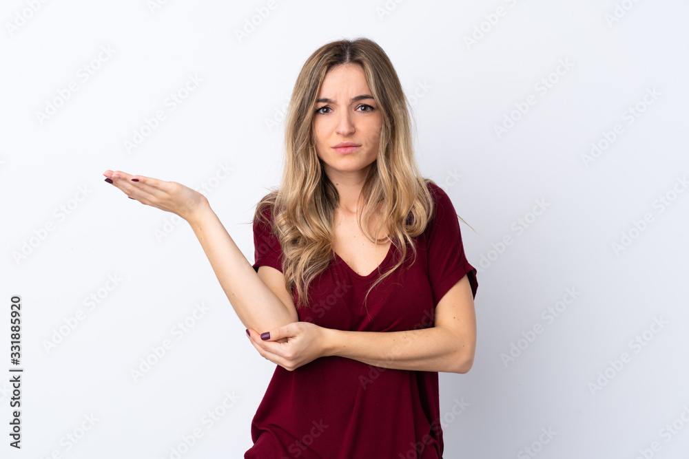 Young woman over isolated white background unhappy for not understand something