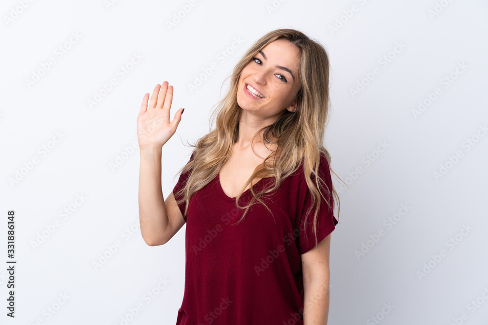 Young woman over isolated white background saluting with hand with happy expression Young woman over isolated white background saluting with hand with happy expression