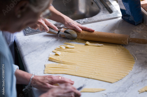 Preparation of Easter cake, also called Pastiera Napoli, typical homemade dessert, with eggs, flour, sugar and vanilla, wheat and colored sugared almonds photo