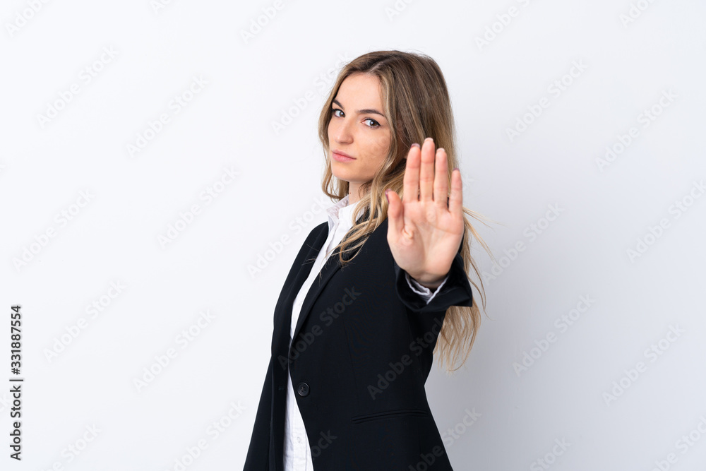 Young business woman over isolated white background making stop gesture with her hand Young business woman over isolated white background making stop gesture with her hand