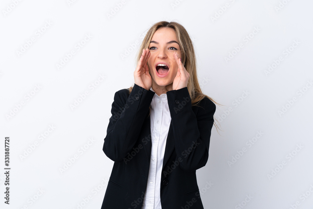 Young business woman over isolated white background shouting with mouth wide open Young business woman over isolated white background shouting with mouth wide open