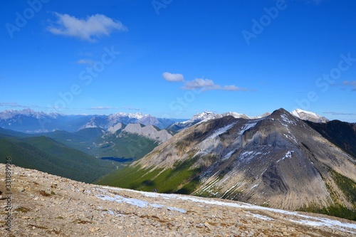 Sulphur skyline trail. Beautiful high mountains covered with snow, green forrest, white clouds, blue sky. National Park Jasper, Canada.