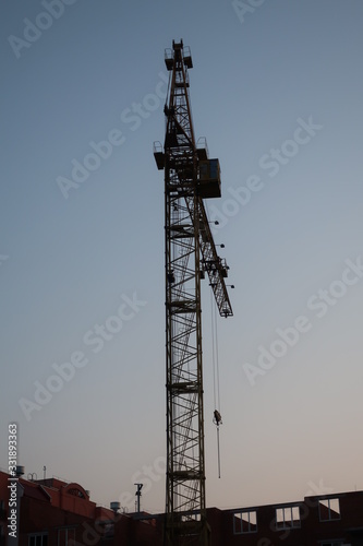  construction crane in focus on a beautiful sunset background