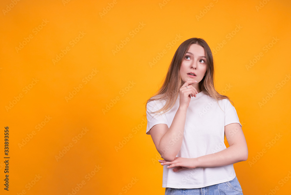 Young emotional girl on a yellow background. Young emotional girl on a yellow background.