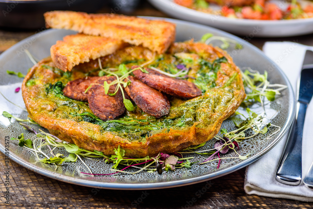 Green Egg Omelette topped with slices of grilled Cacciatore Salami Green Egg Omelette topped with slices of grilled Cacciatore Salami