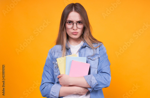 Cute funny student with books in glasses.