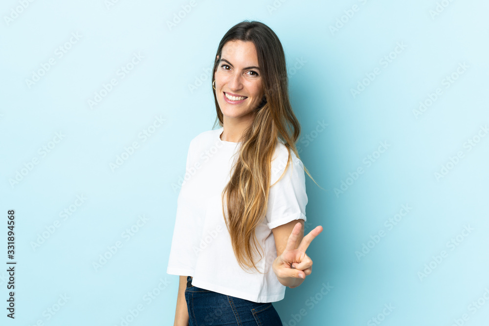 Young caucasian woman over isolated background smiling and showing victory sign Young caucasian woman over isolated background smiling and showing victory sign