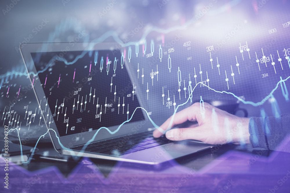 Double exposure of stock market graph with man working on laptop on background. Concept of financial analysis. Double exposure of stock market graph with man working on laptop on background. Concept of financial analysis.