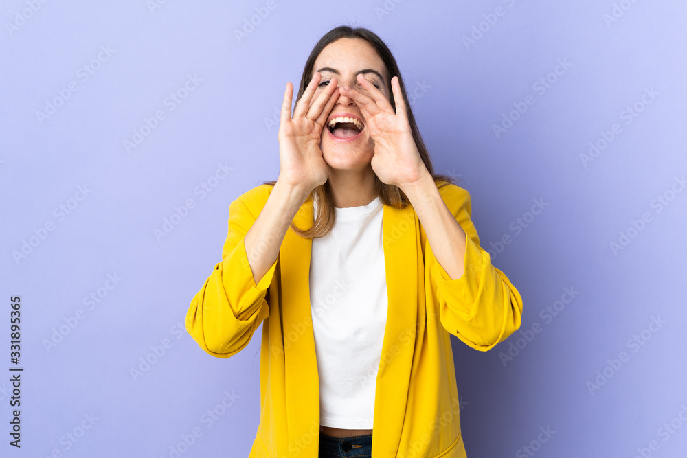 Young caucasian woman over isolated background shouting and announcing something Young caucasian woman over isolated background shouting and announcing something