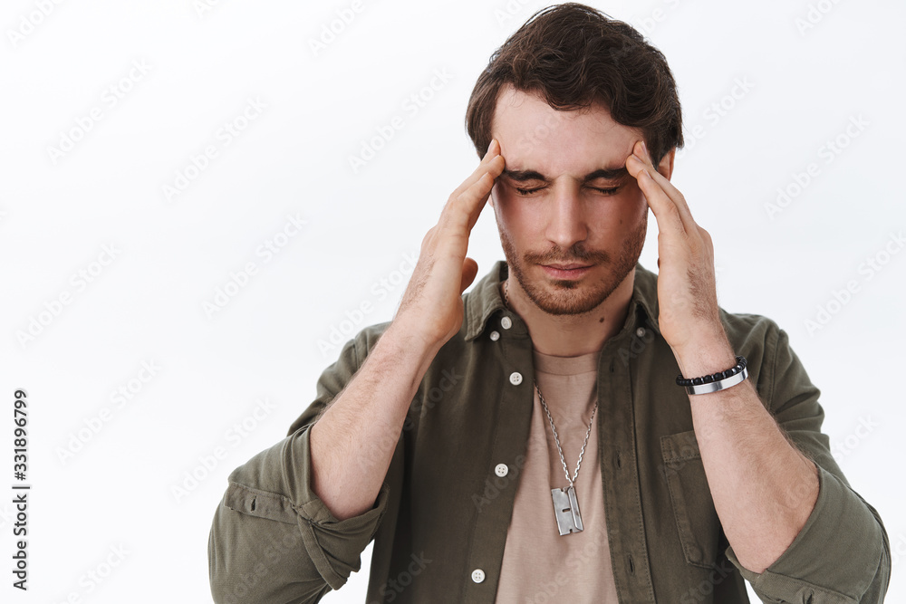 Expressions of pain and discomfort, health concept. Close-up portrait of upset guy close eyes and massage temples from headache, suffer painful migraine or hangover, standing white background