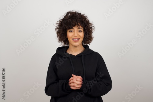 Wow. Beautiful female half-length front portrait isolated on gray studio background. Young emotional surprised woman standing with open mouth. Human emotions, facial expression concept. Trendy colors.