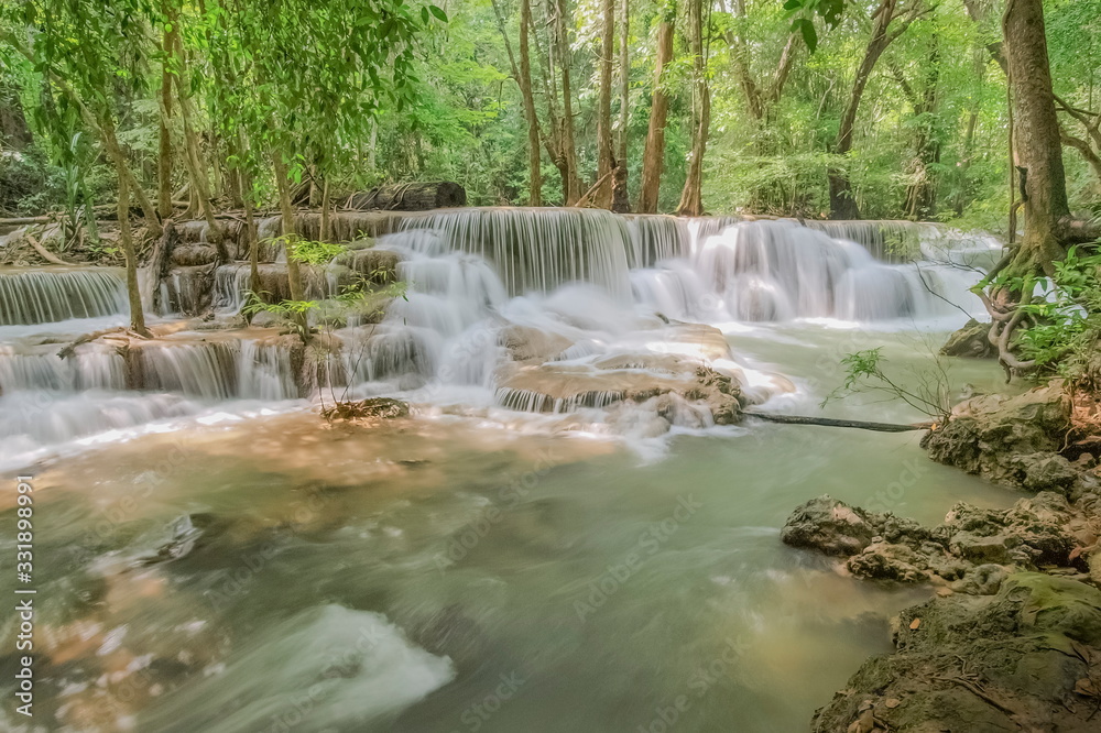 Beautiful soft silky white water flowing on arch rock with green forest background, Huay Mae Khamin Waterfall floor 6th (Dong Pee Sua) Kanchanaburi, west of Thailand.