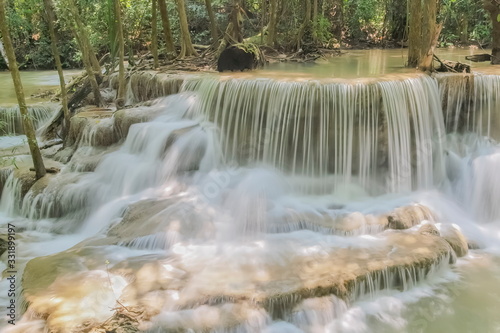 Beautiful soft silky white water flowing on arch rock with nature background, Huay Mae Khamin Waterfall floor 6th (Dong Pee Sua) Kanchanaburi, west of Thailand.