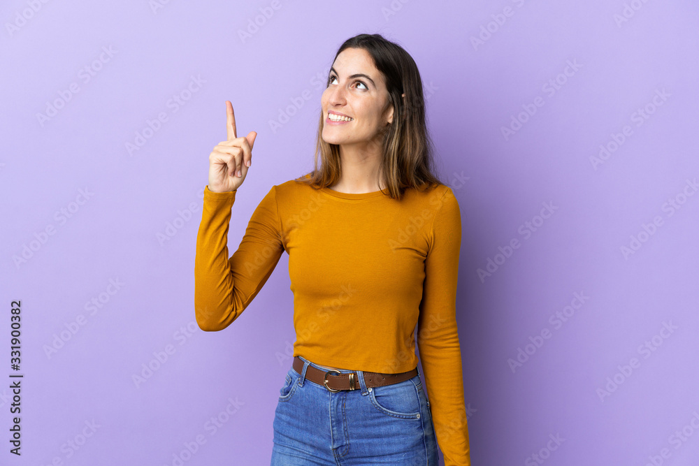 Young caucasian woman over isolated background pointing up and surprised Young caucasian woman over isolated background pointing up and surprised