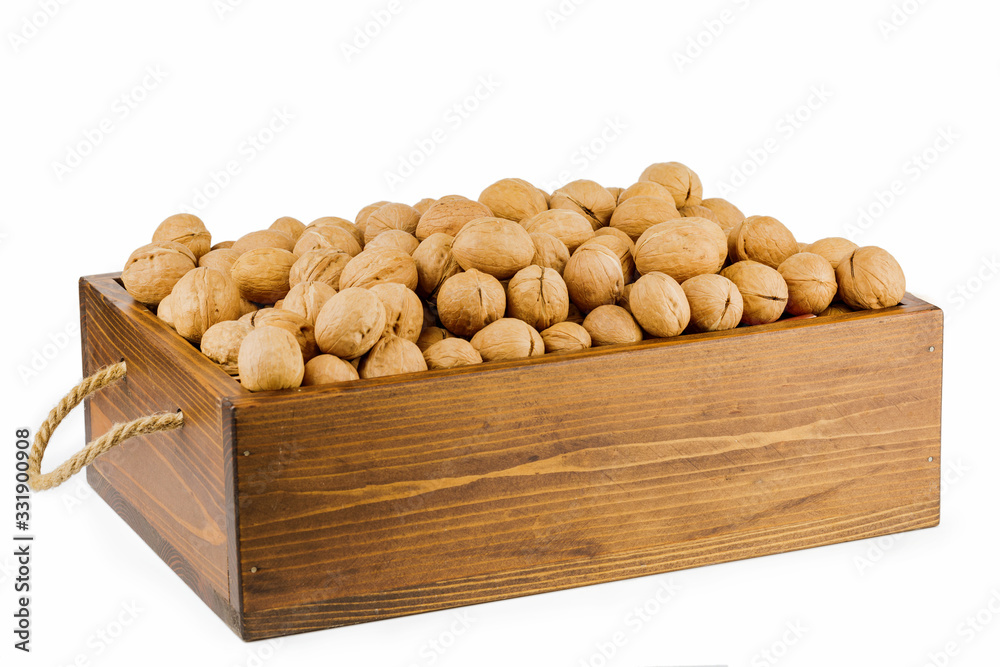 wooden box with raw walnuts isolated on white background wooden box with raw walnuts isolated on white background
