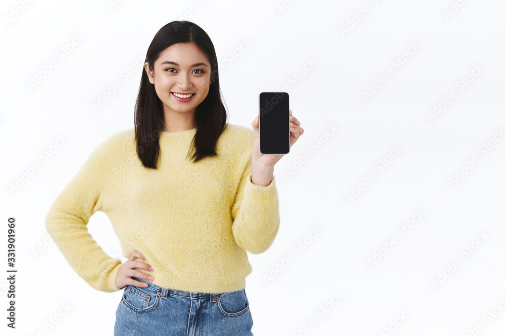 Kawaii asian girl with short dark hair holding mobile phone and showing smartphone screen, advertisement of company website or messanger, recommend download game or app Kawaii asian girl with short dark hair holding mobile phone and showing smartphone screen, advertisement of company website or messanger, recommend download game or app