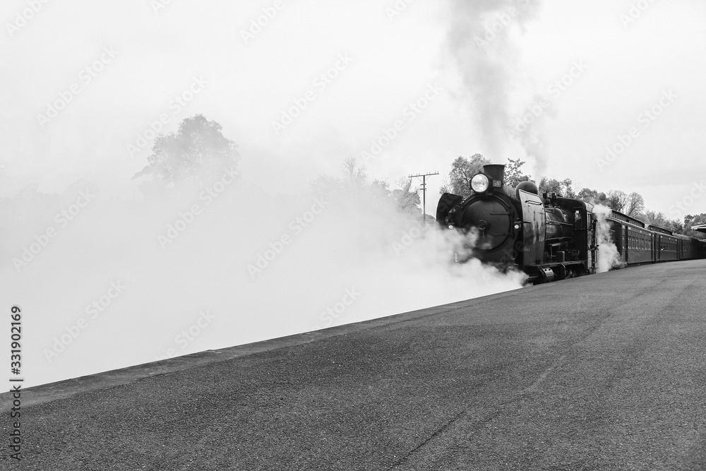 CASTLEMAINE, AUSTRALIA - June 9, 2019: The K 153 steam engine pulling the Maldon to Castlemaine tourist railway carriages departs Castlemaine railway station CASTLEMAINE, AUSTRALIA - June 9, 2019: The K 153 steam engine pulling the Maldon to Castlemaine tourist railway carriages departs Castlemaine railway station