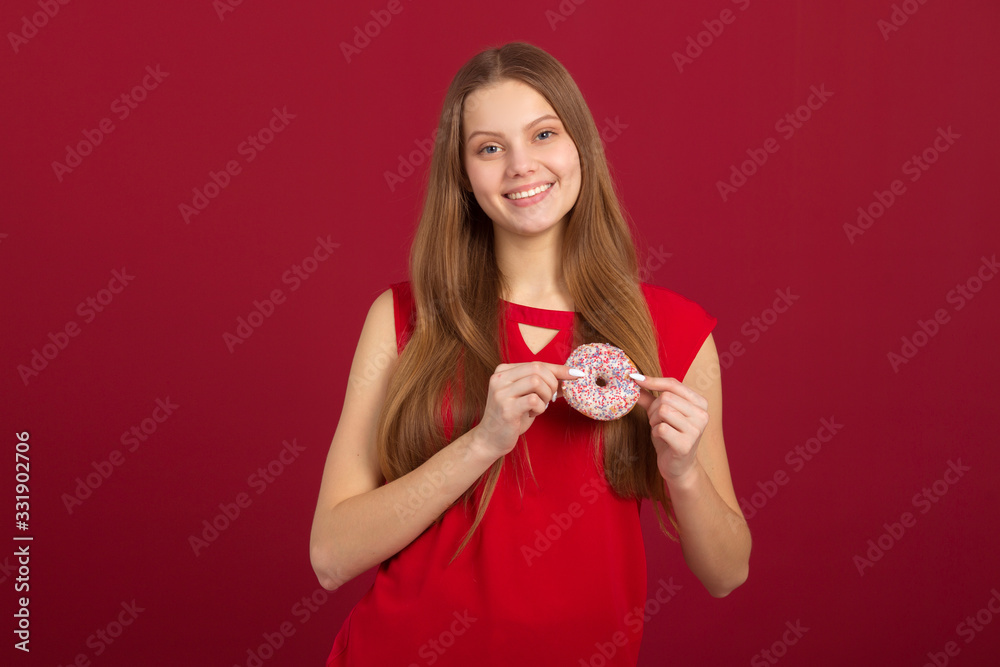 beautiful young woman with her hair on a red background with donuts beautiful young woman with her hair on a red background with donuts