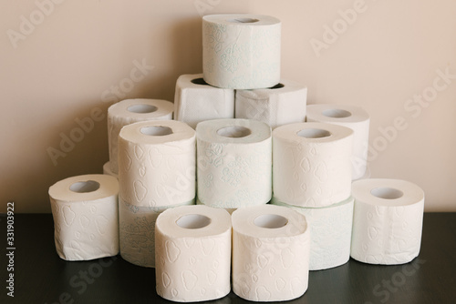 Toilet paper roll background with text toilet paper to 1 package per household. Concept of lack of toilet paper in stores due to coronavirus, Covid-19, hygiene, panic.