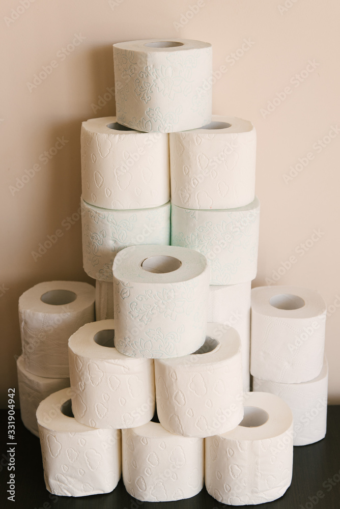Toilet paper roll background with text toilet paper to 1 package per household. Concept of lack of toilet paper in stores due to coronavirus, Covid-19, hygiene, panic. Toilet paper roll background with text toilet paper to 1 package per household. Concept of lack of toilet paper in stores due to coronavirus, Covid-19, hygiene, panic.