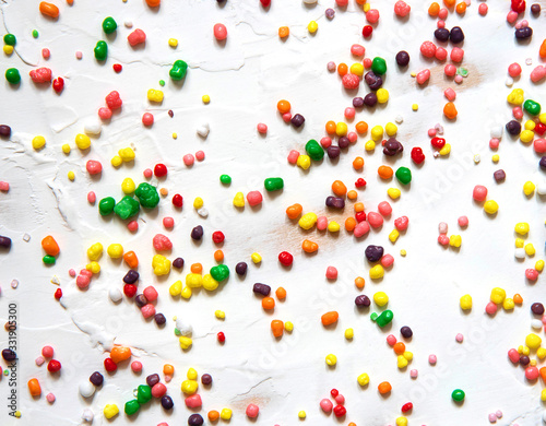 Obraz na płótnie Rainbow colored candy sprinkled on a white background