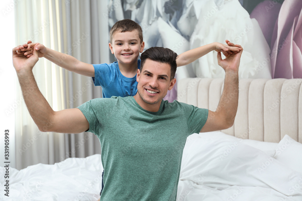 Dad and son having fun together at home. Happy Father's Day